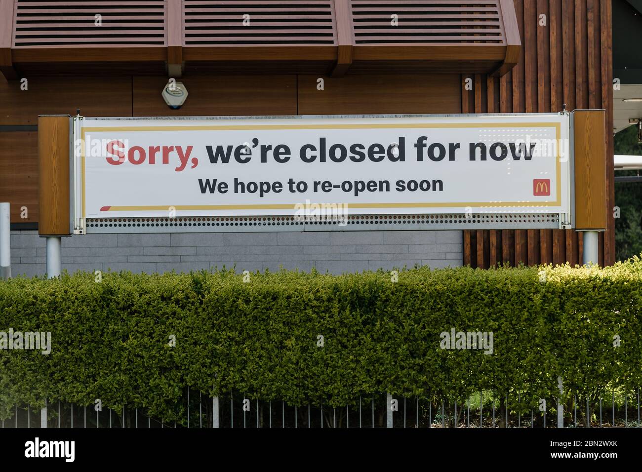 MERTHYR TYDFIL, WALES - 11 MAY 2020 - A Mcdonalds sign telling customer that they are sorry they are closed and will open again soon. Stock Photo