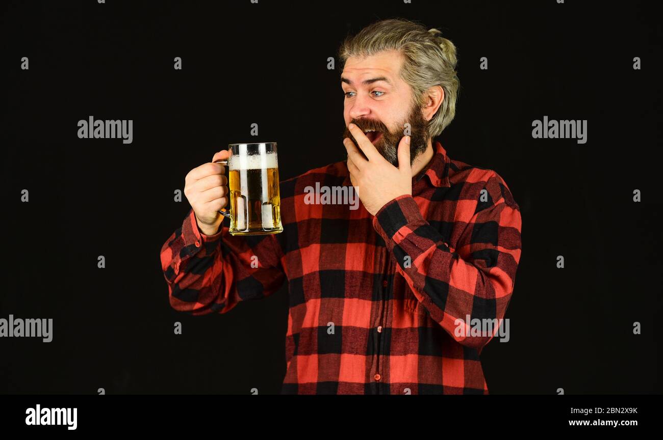 surprised male brewer. brutal hipster drink beer. mature bearded man hold beer glass. mug of alcohol beverage. confident bartender. barman in bar. resting at pub. Cheers. sport bar. trying a new beer. Stock Photo