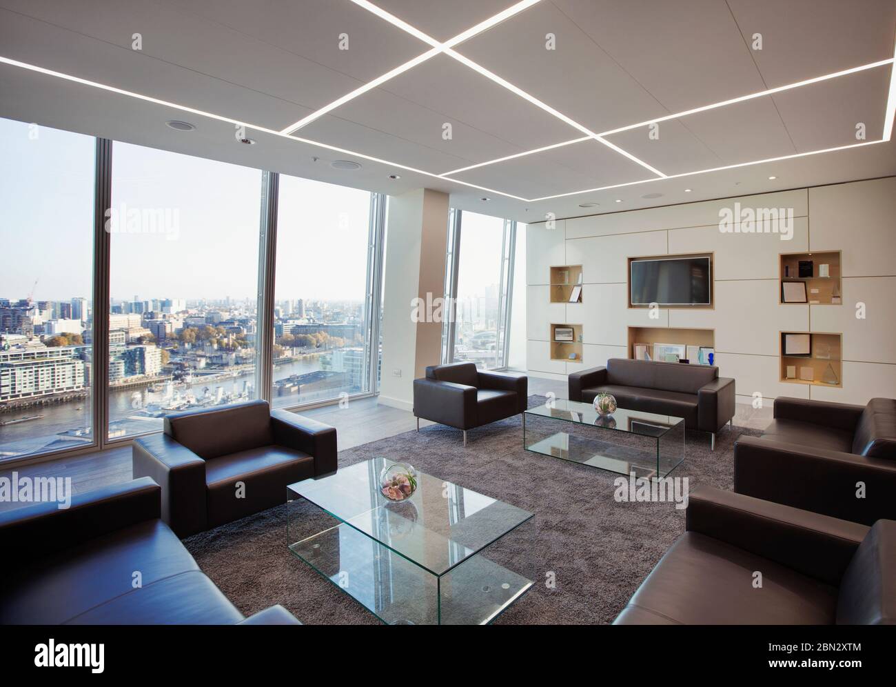 Modern highrise business office lobby overlooking city Stock Photo