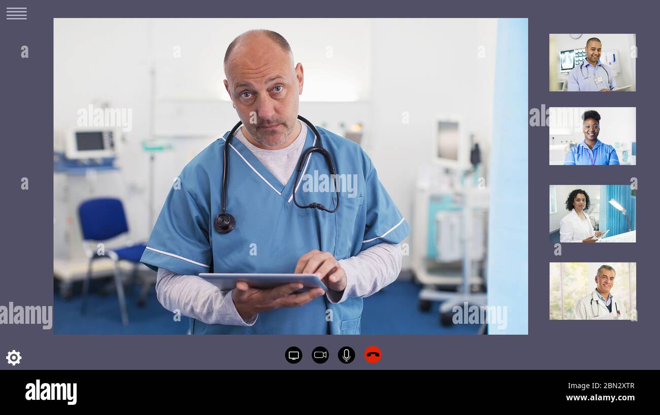 Doctor video conferencing with colleagues during COVID-19 pandemic Stock Photo