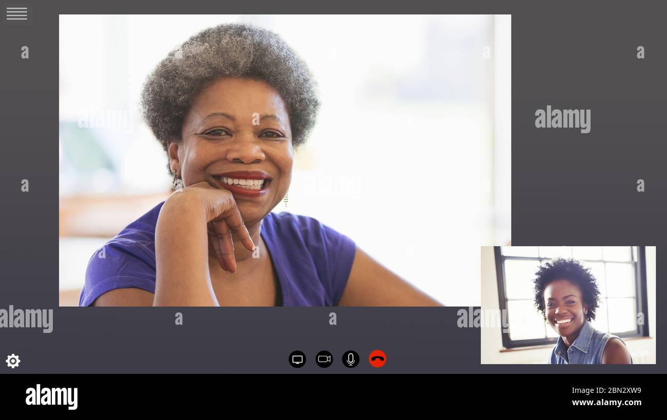 Happy mother and daughter video conferencing in COVID-19 quarantine Stock Photo