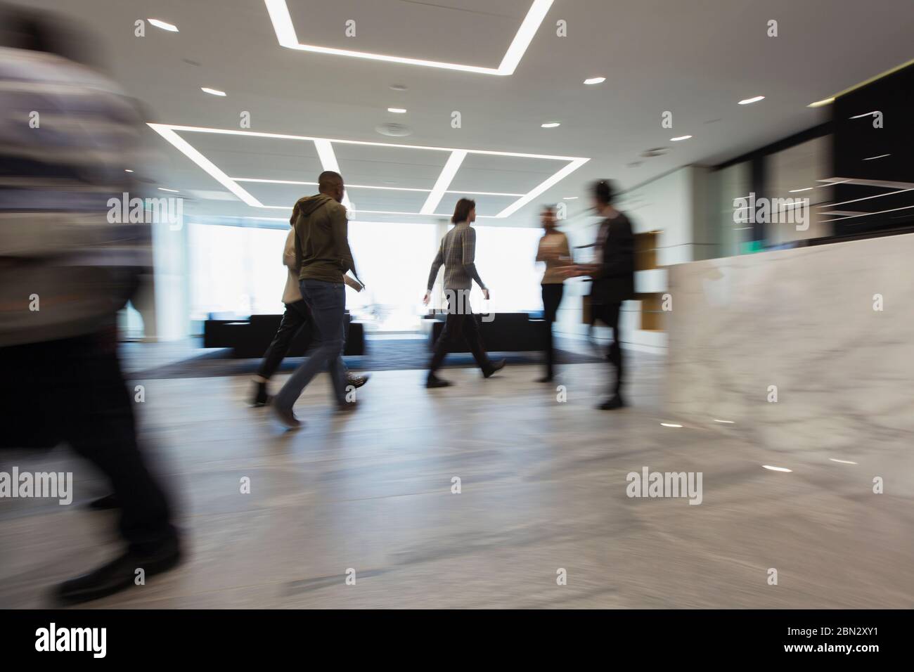 Business people walking in office lobby Stock Photo
