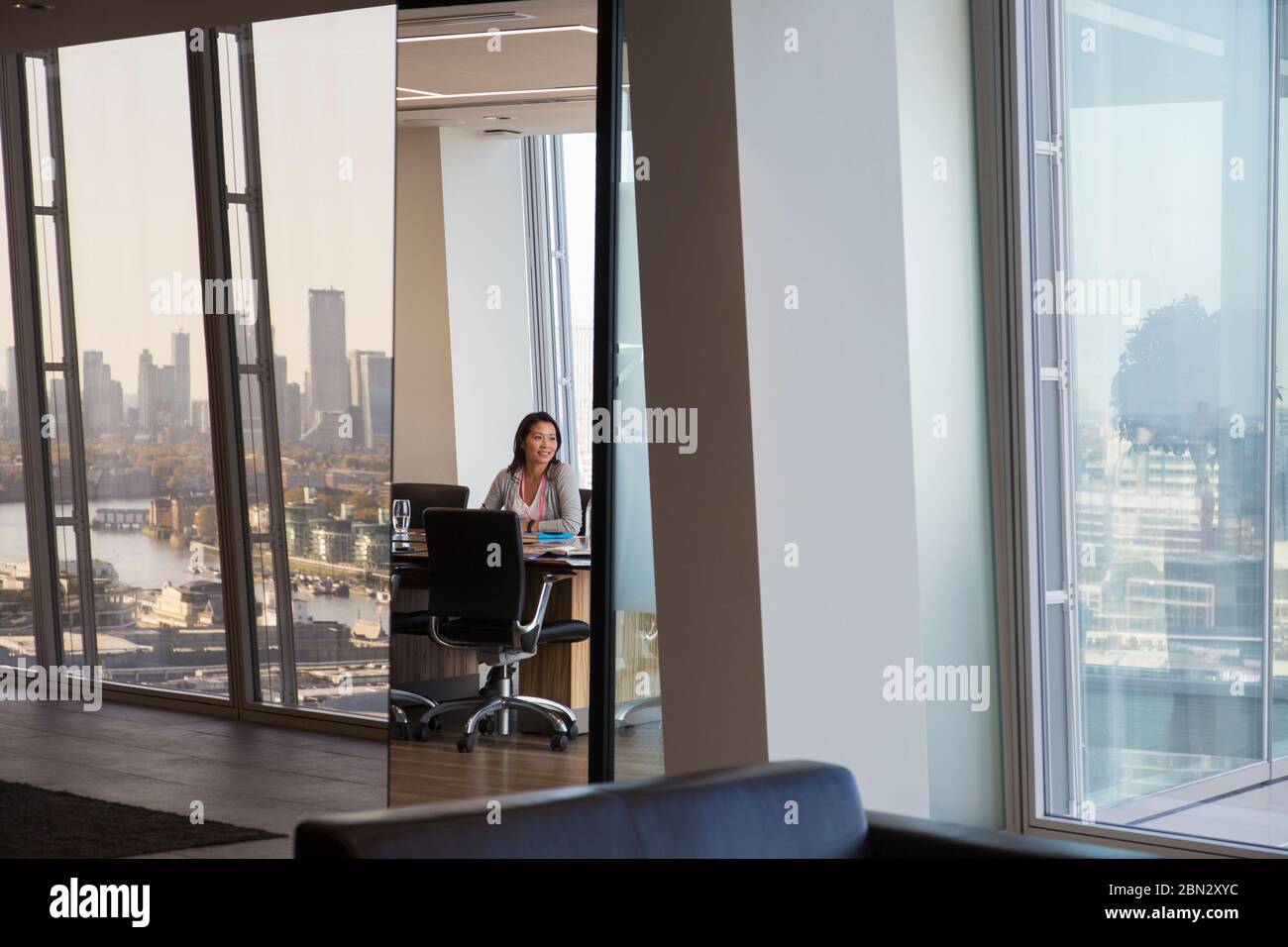 Businesswoman in urban highrise conference room Stock Photo