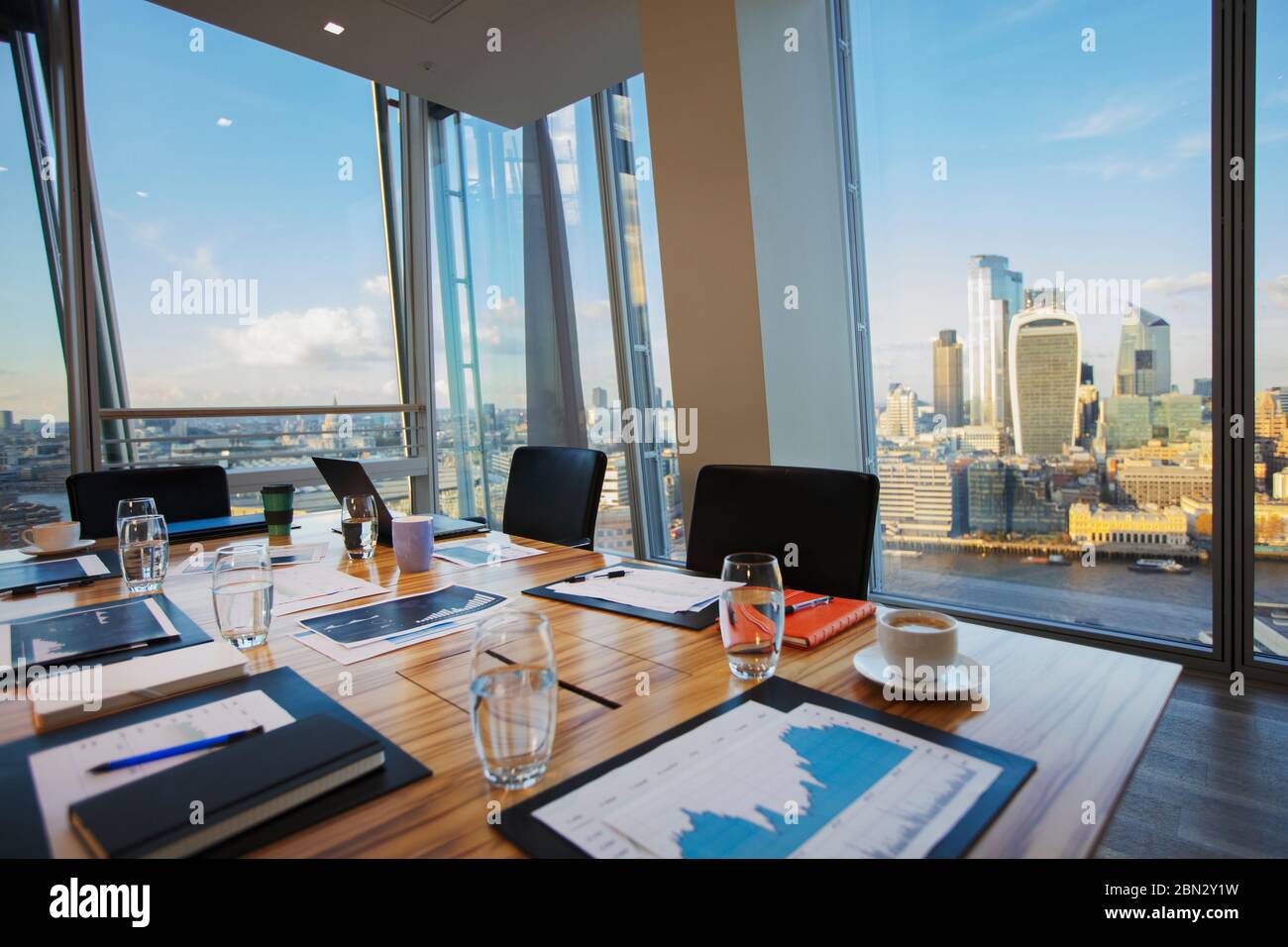 Modern conference room overlooking highrise buildings and city Stock Photo