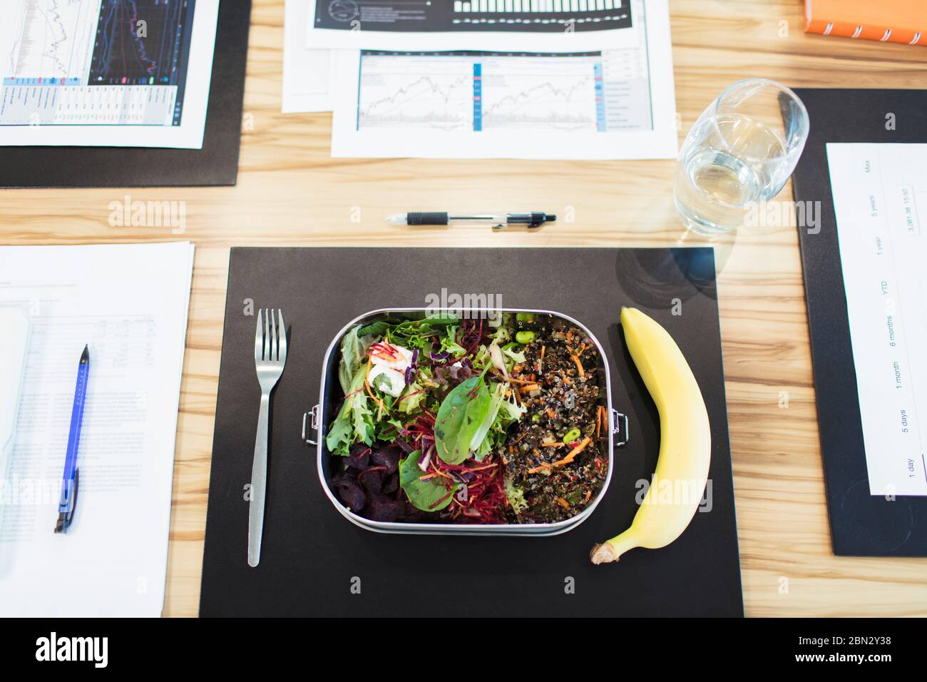 Healthy salad and banana lunch on conference table Stock Photo