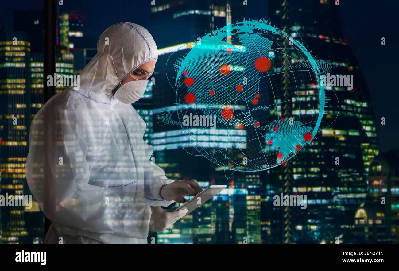 Scientist in clean suit working late during coronavirus pandemic Stock Photo