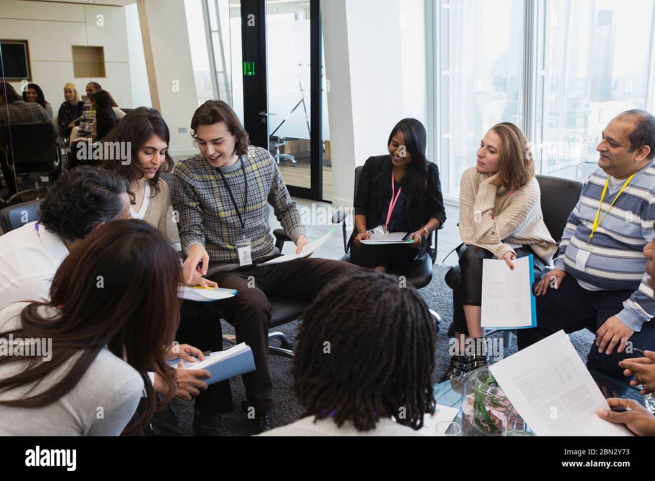 Business people talking in circle in conference room meeting Stock Photo