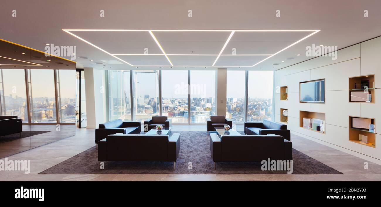 Sofas in modern urban highrise office lounge Stock Photo