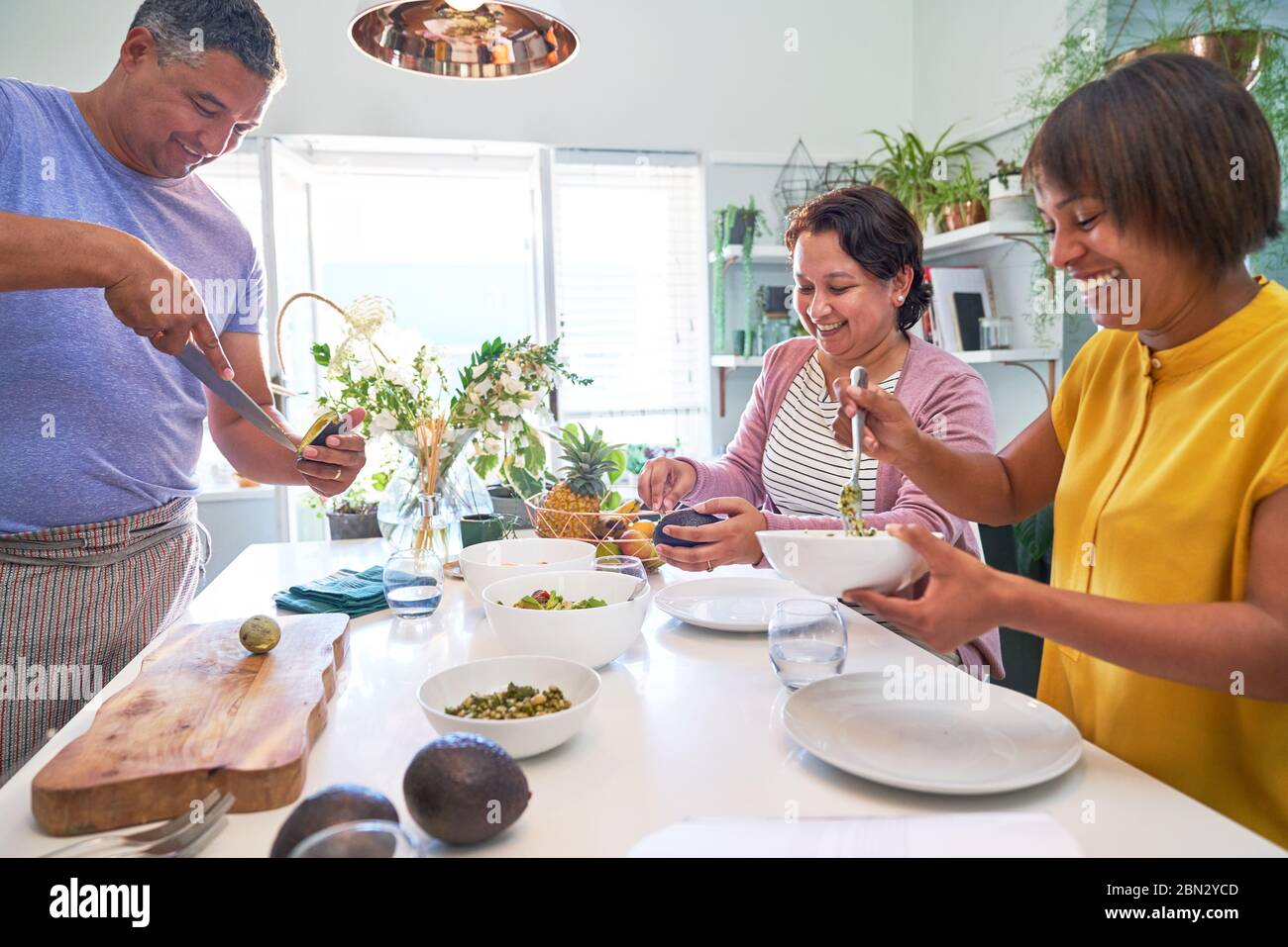 Mature friends cooking in kitchen Stock Photo