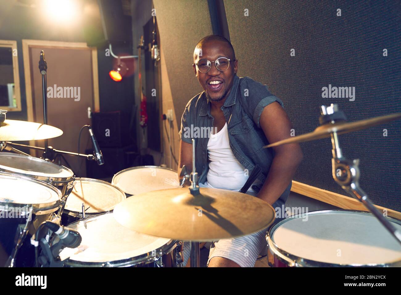 Portrait confident male drummer at drum kit Stock Photo