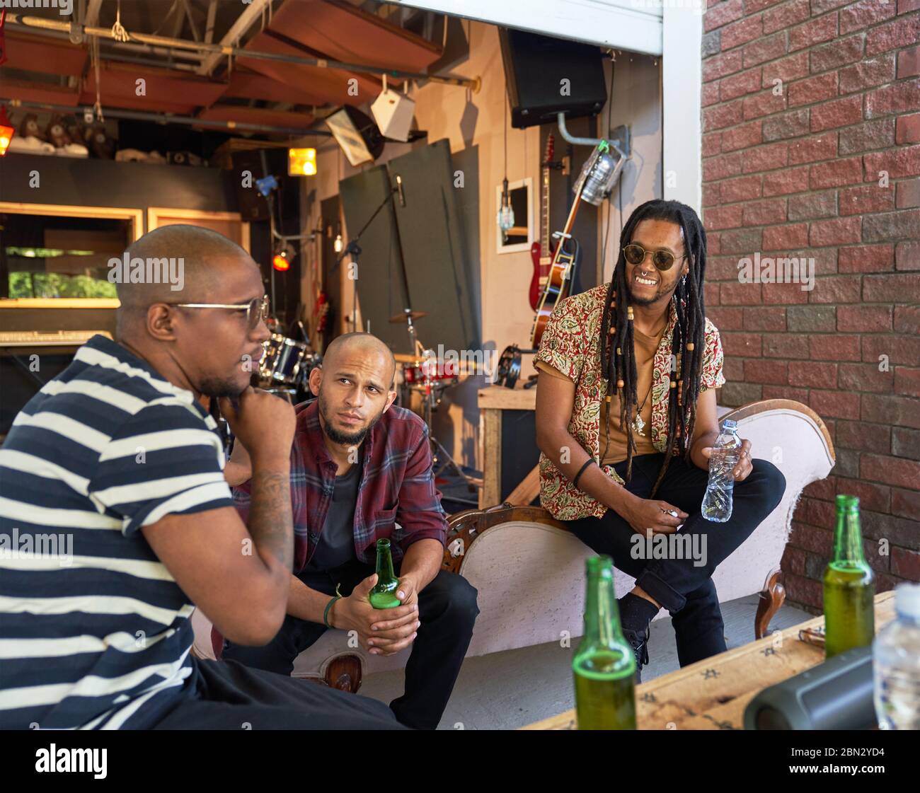 Male musician friends hanging out and drinking beer Stock Photo