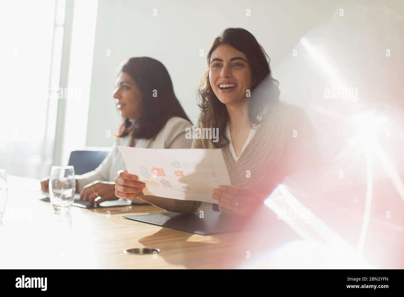 Happy businesswoman with flow chart in meeting Stock Photo