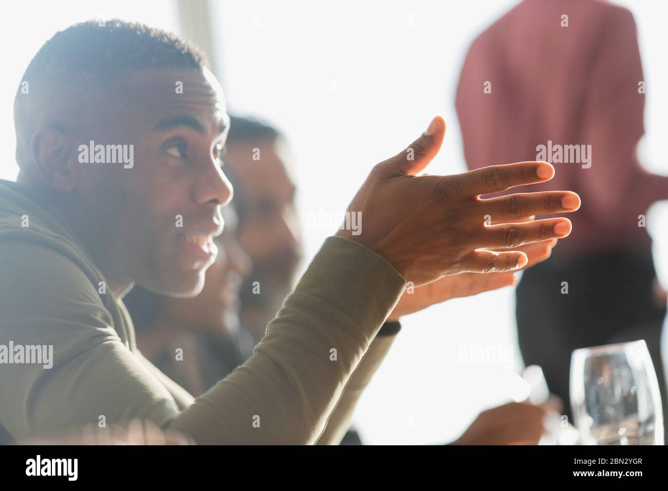 Businessman gesturing and explaining in office meeting Stock Photo
