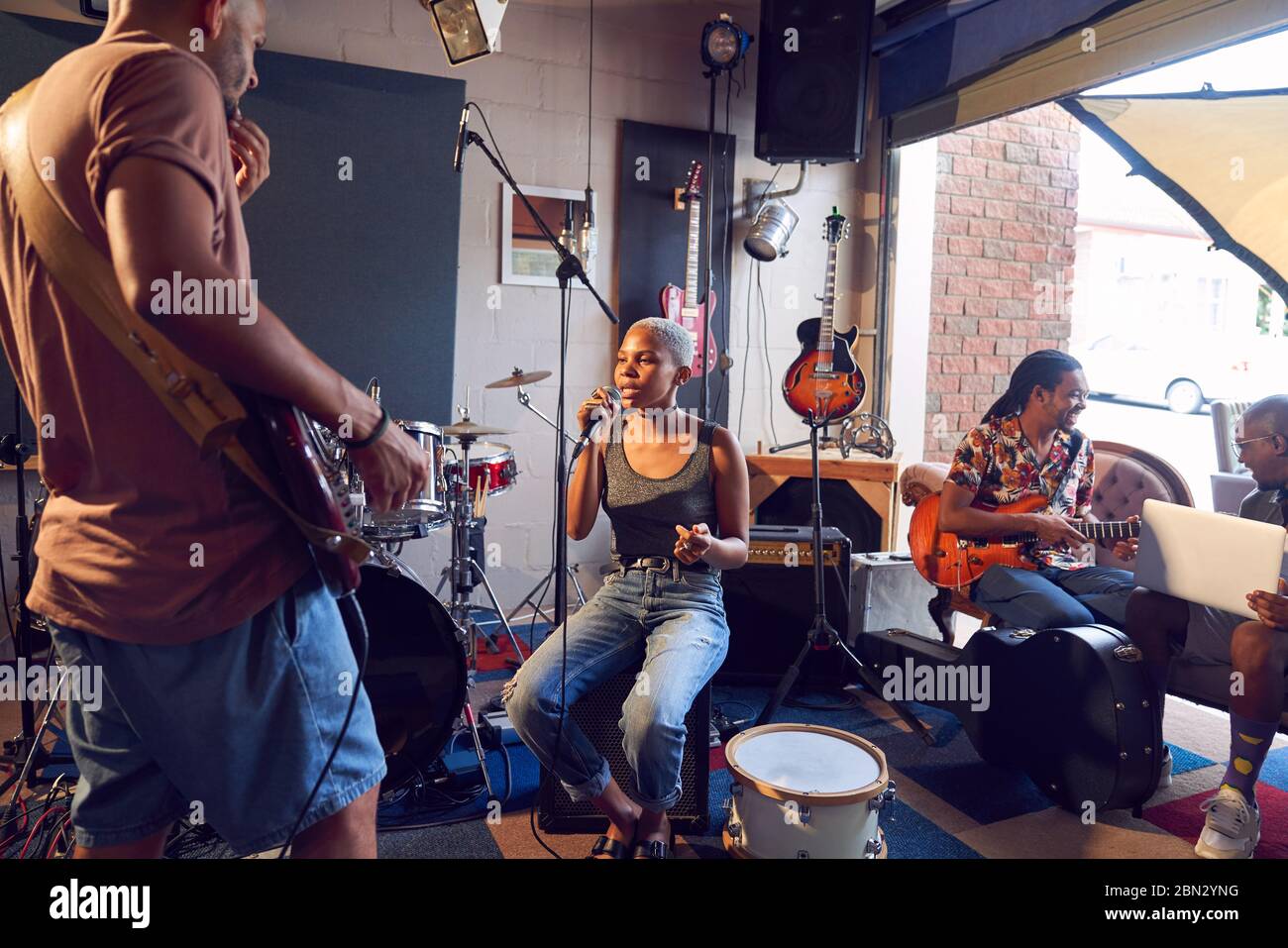 Musicians practicing in garage recording studio Stock Photo