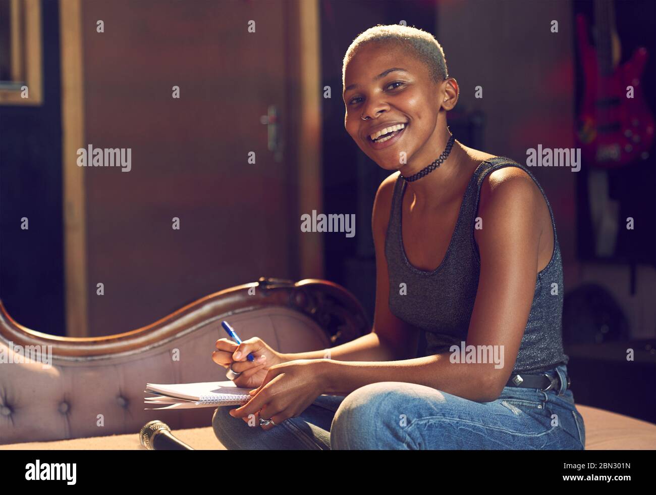 Portrait confident female musician song writing Stock Photo
