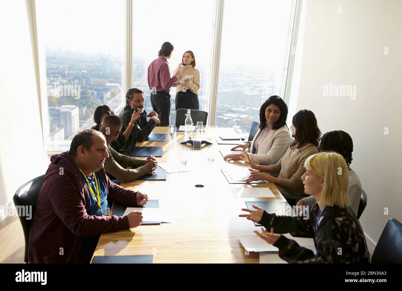 Business people talking in sunny conference room meeting Stock Photo