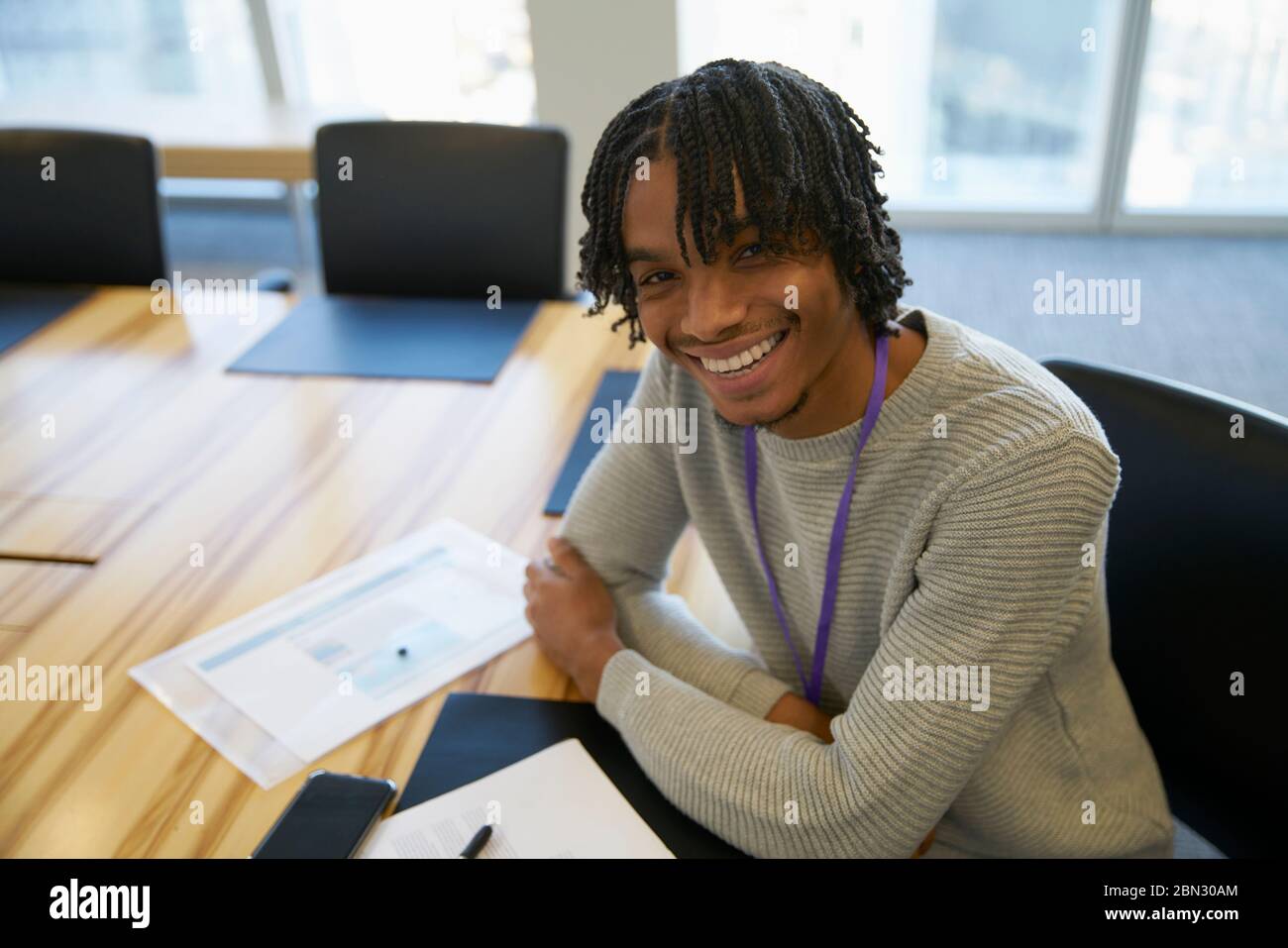 Portrait confident businessman with paperwork in conference room Stock Photo