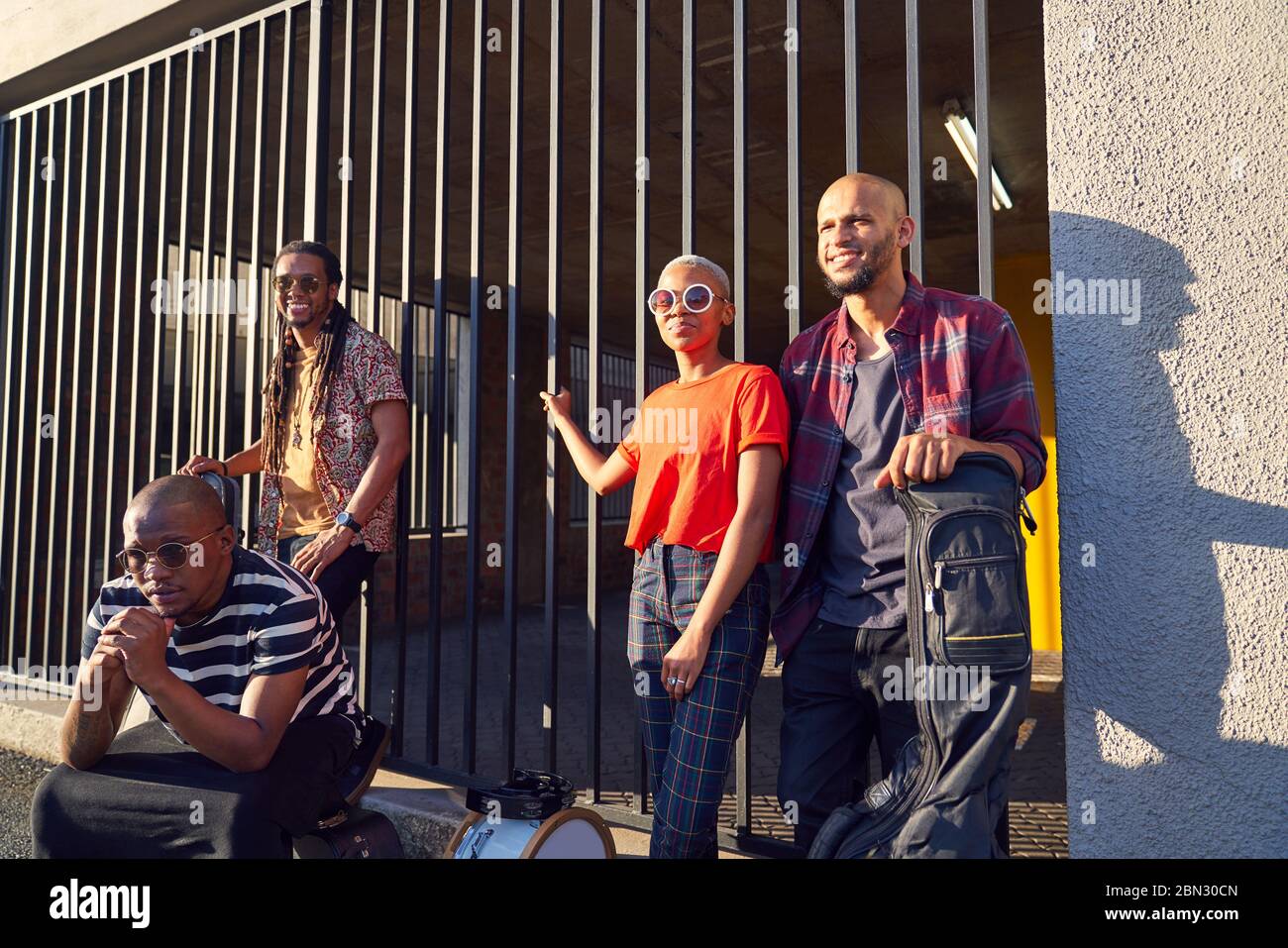 Portrait confident musicians outside sunny parking garage Stock Photo