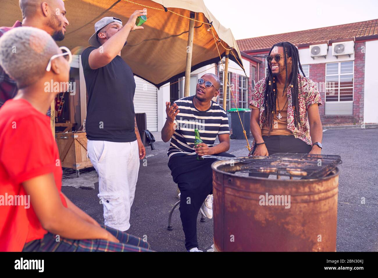 Friends hanging out and barbecuing in parking lot Stock Photo