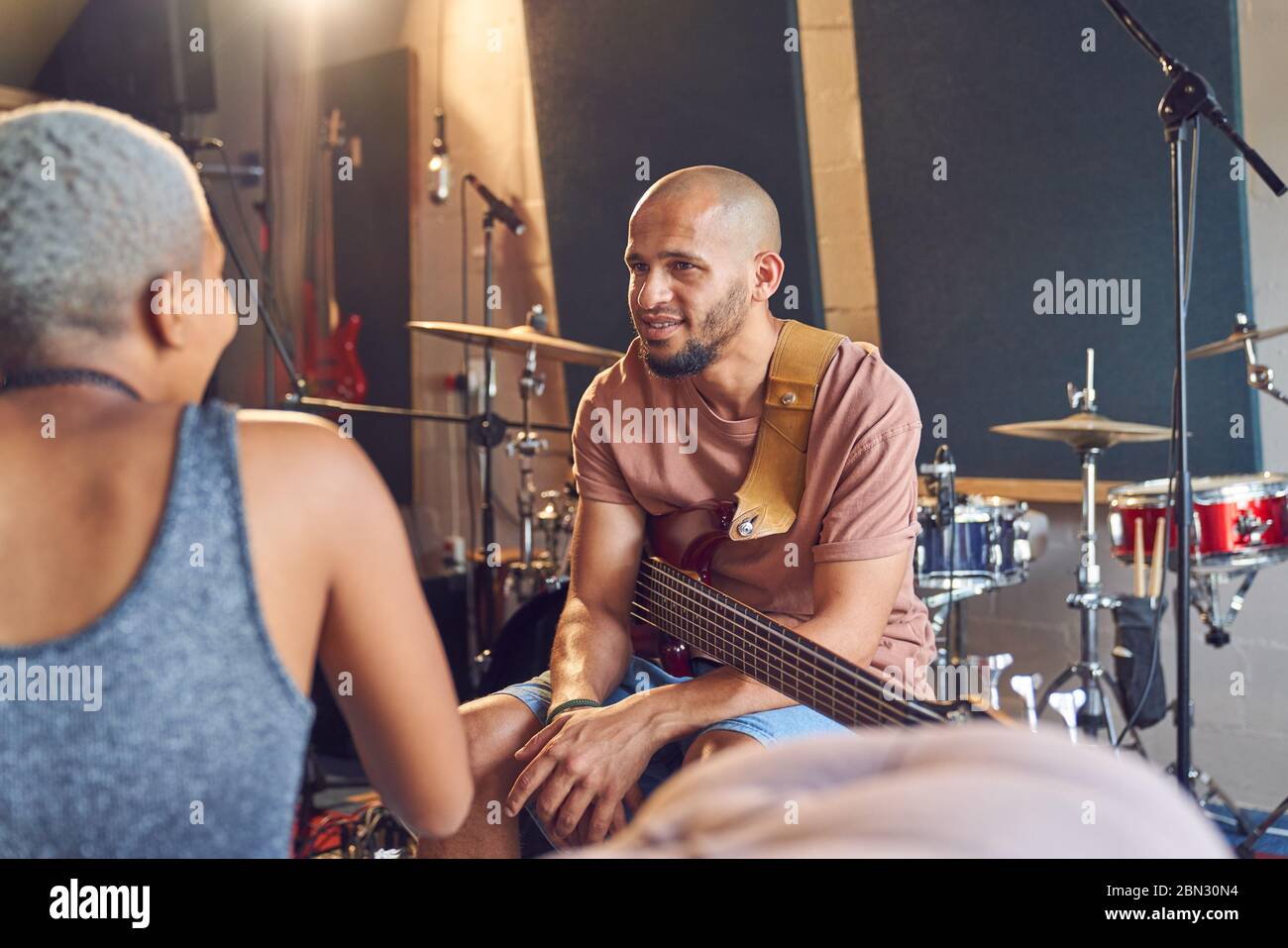 Musicians talking and practicing in recording studio Stock Photo