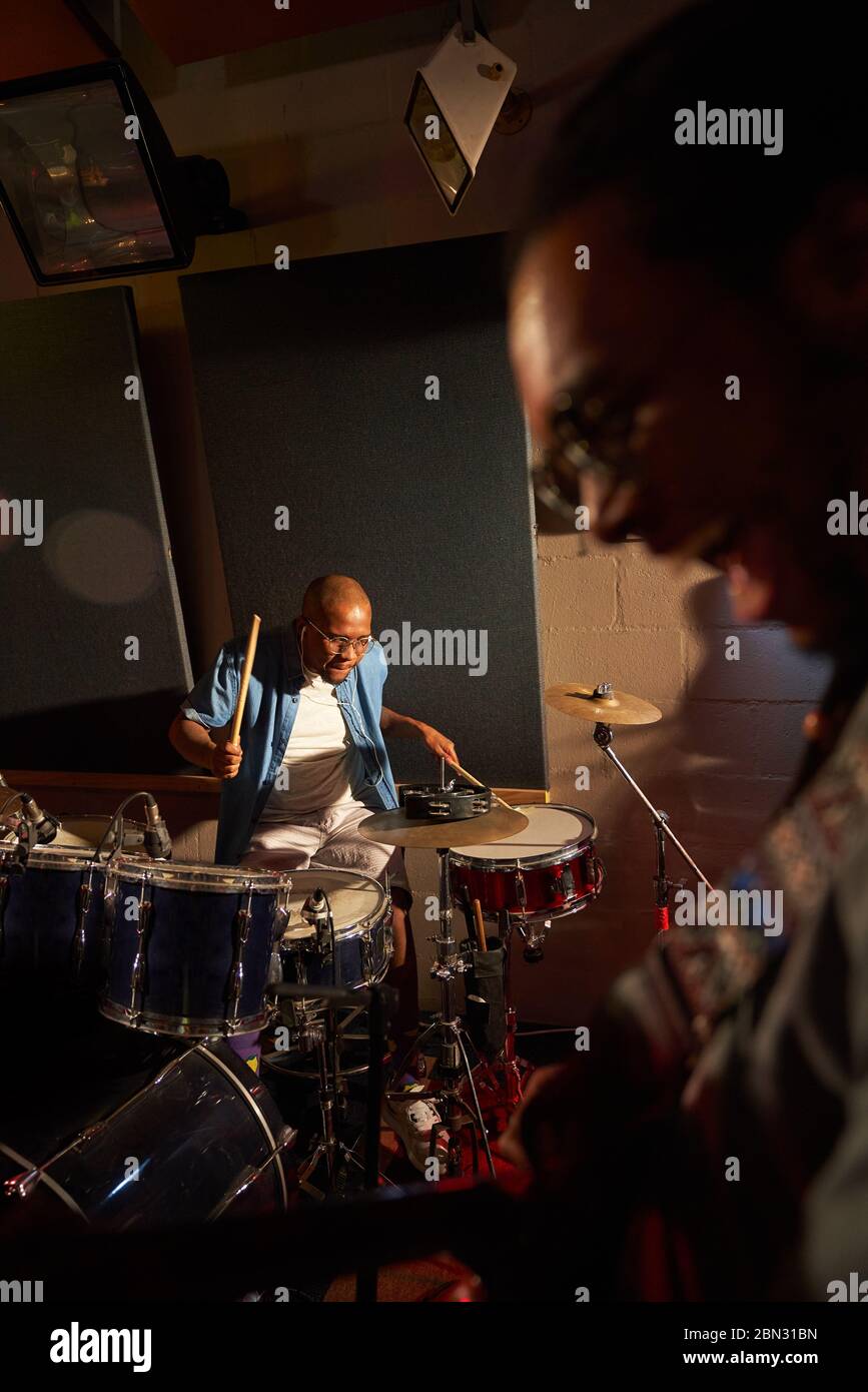 Male musician playing drums in recording studio Stock Photo - Alamy