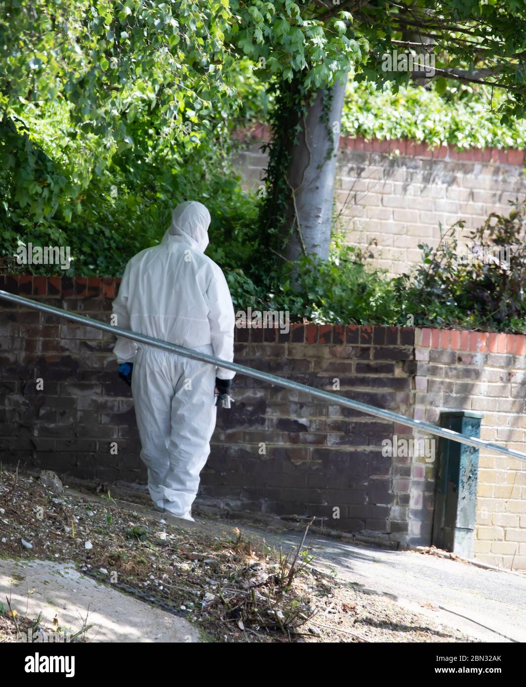 Biggin Hill, Kent, UK. 12th May, 2020. A man in white Personal Protective Equipment from Clarion, waits outside a property in Biggin Hill, Kent before entering because of Covid-19. Credit: Keith Larby/Alamy Live News Stock Photo