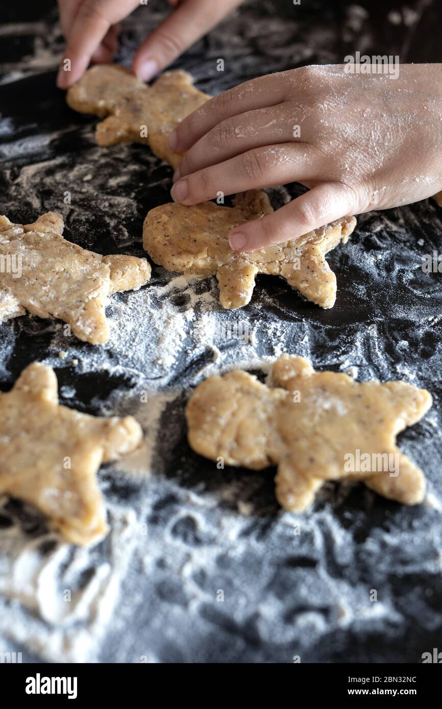 Person baking Gingerbread man cookies, Person hands in dough with ...