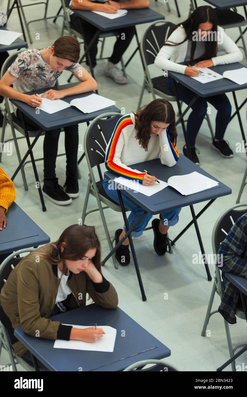 High school students taking exam at tables Stock Photo