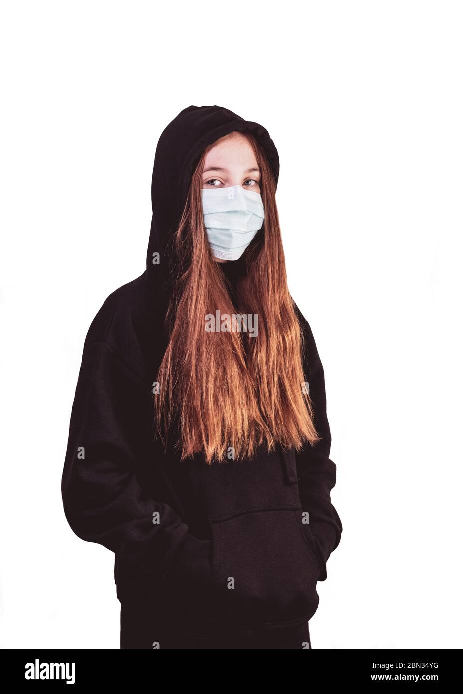 teenage girl wearing a medical mask  for protection against corona virus and other health problems on a white isolated background, teen youth has a bl Stock Photo