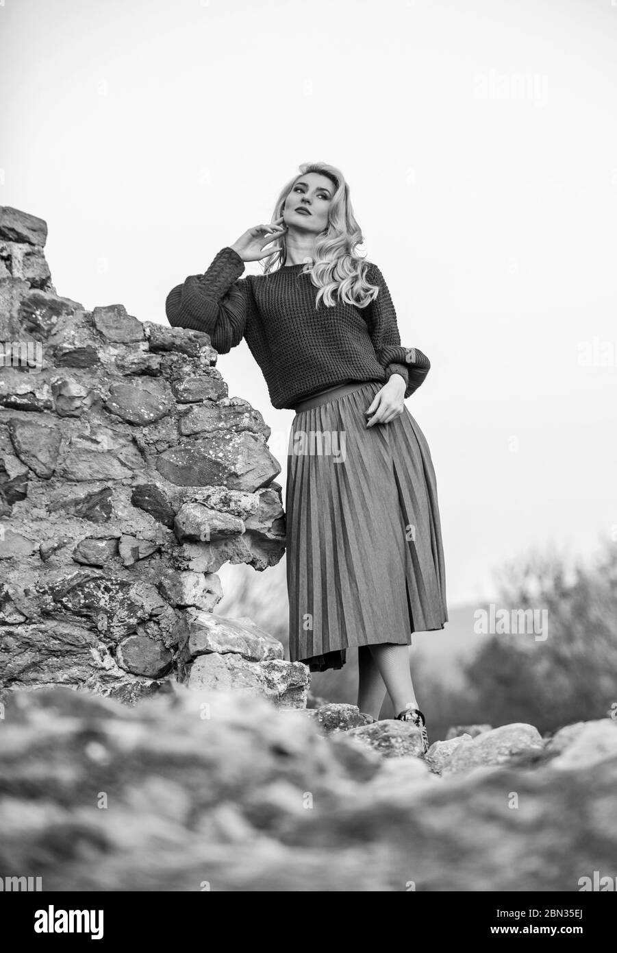 Elegance concept. Fancy girl makeup face wear knitted sweater. Messy chic style. Gorgeous lady feeling cozy in woolen sweater. Trendy clothes. Woman warm sweater nature background defocused. Stock Photo