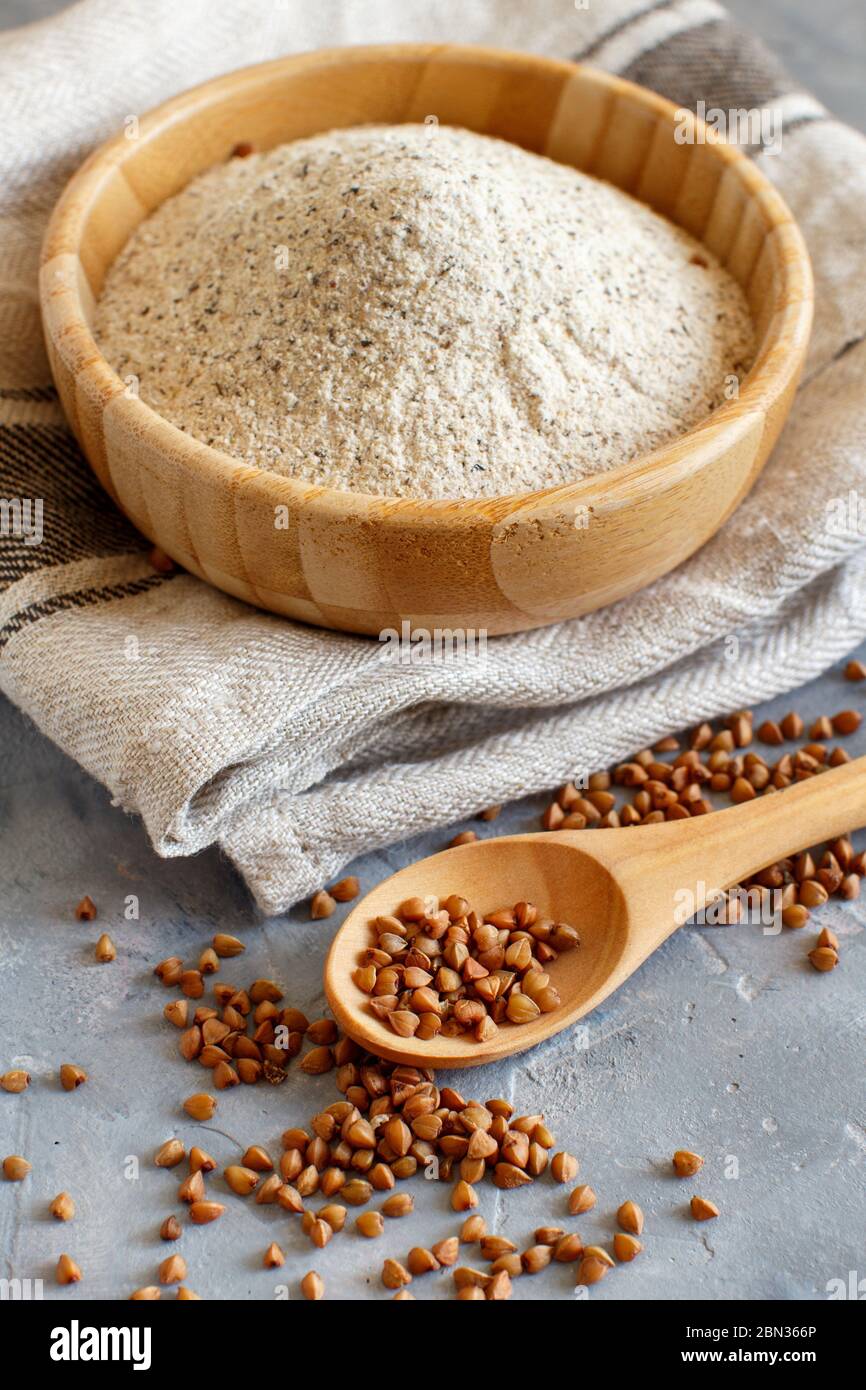 Buckwheat flour in a bowl and buckwheat grain close up Stock Photo Alamy