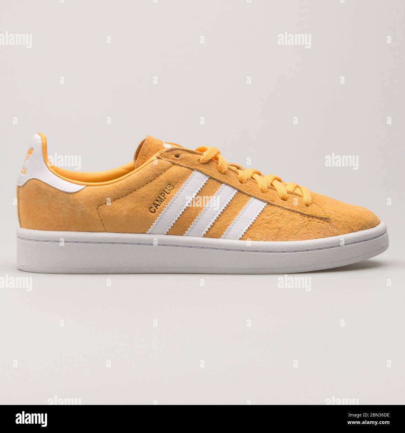 VIENNA, AUSTRIA - AUGUST 13, 2018: Adidas Campus yellow and white sneaker on white background. Stock Photo