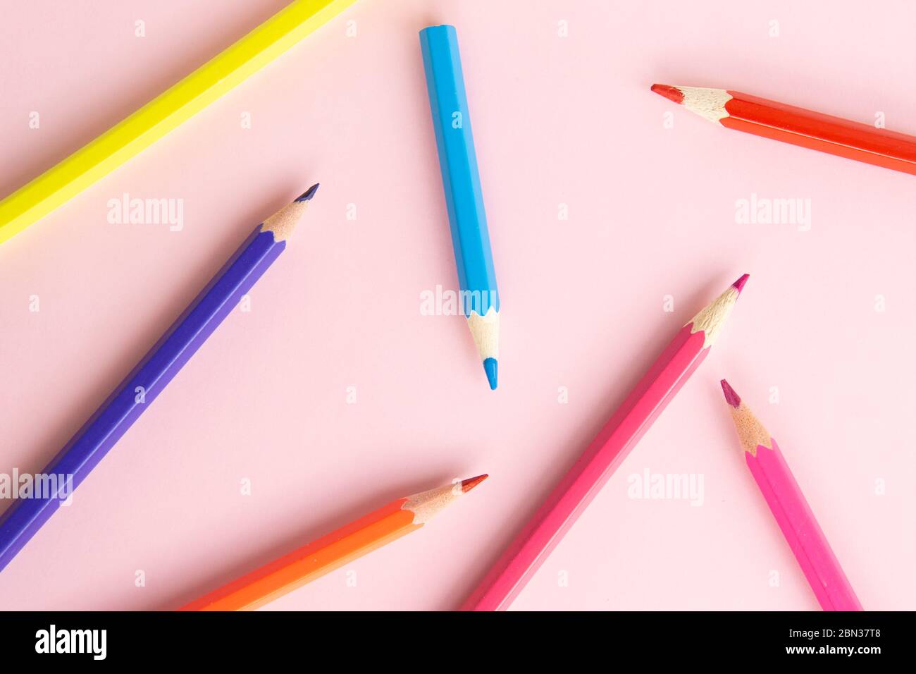 Background image of colorful pencils. Pencils on pink background. Back to school, education and learning concept. Minimalist isometric concept. Stock Photo