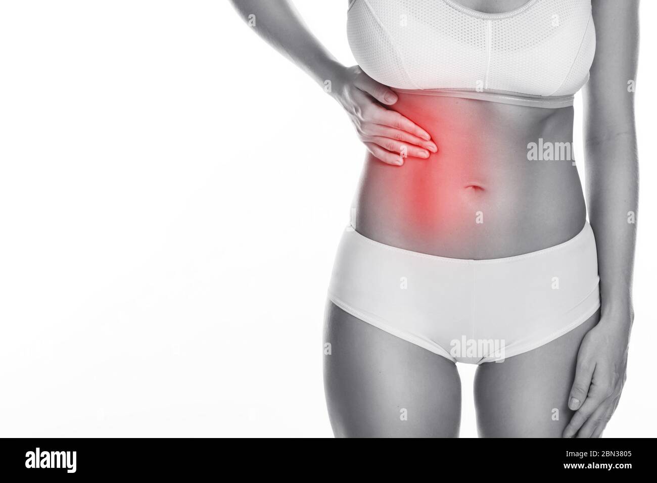 Woman is feeling pain under her ribs. Liver problem. Isolated on white background Stock Photo