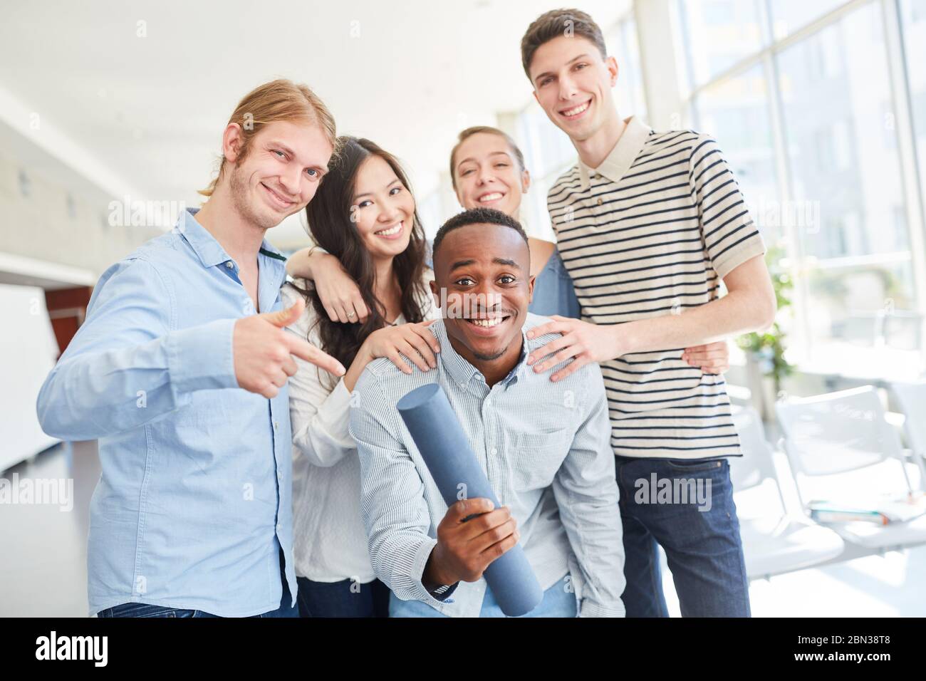 Happy group of students celebrating their graduation from university ...