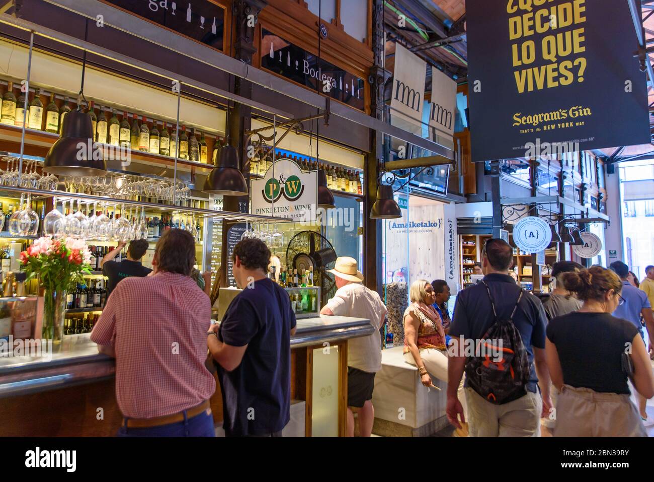 People enjoying food and shopping in Market of San Miguel in Madrid, Spain Stock Photo
