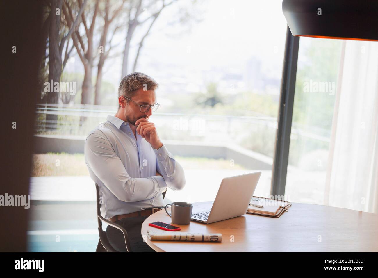 Businessman using laptop, working from home Stock Photo
