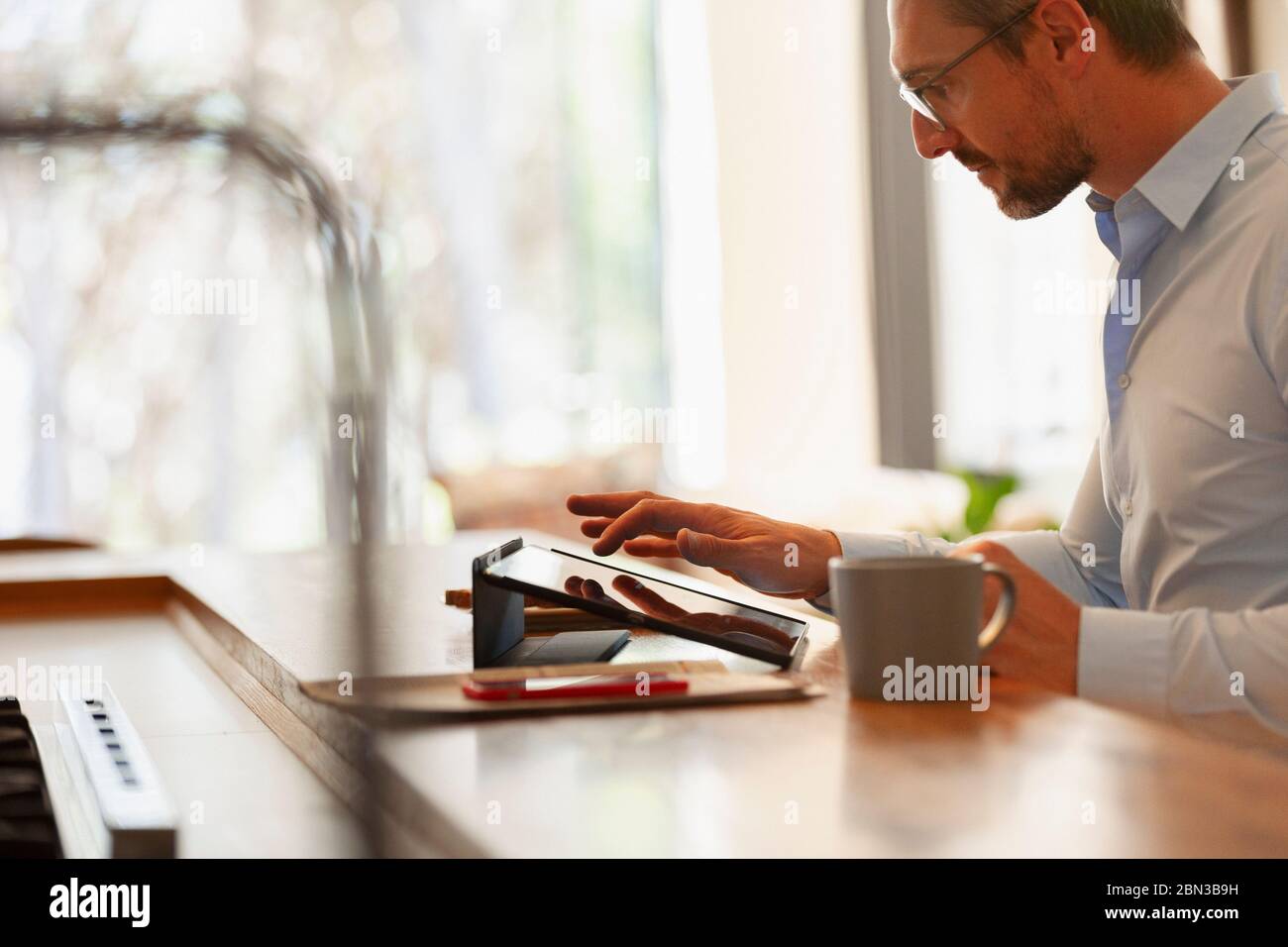 Businessman using digital tablet, working from home Stock Photo