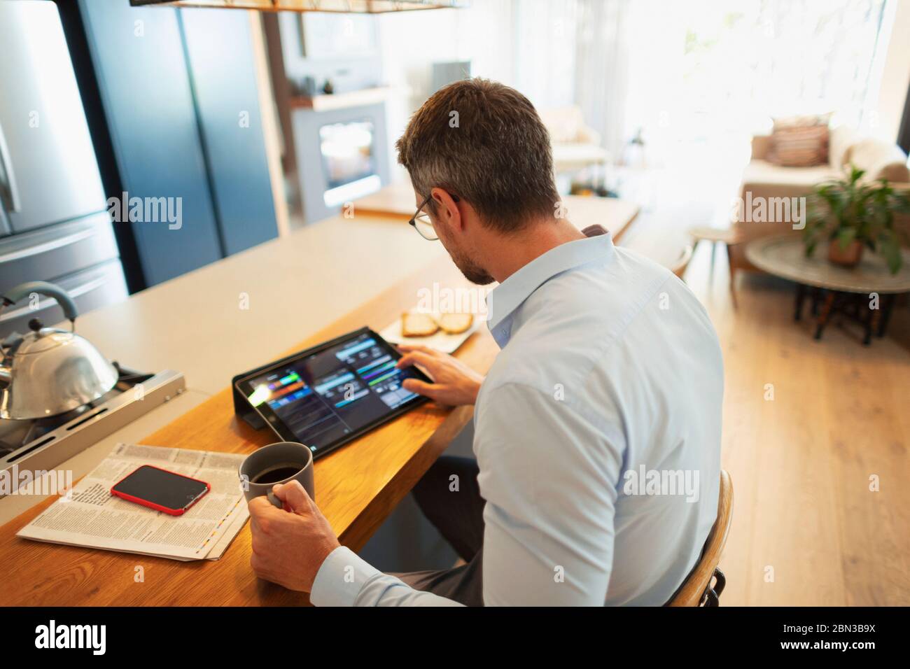 Businessman using digital tablet, working from home Stock Photo