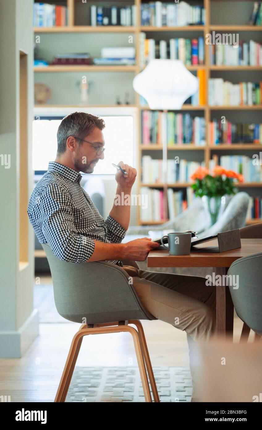 Businessman using digital tablet, working from home Stock Photo
