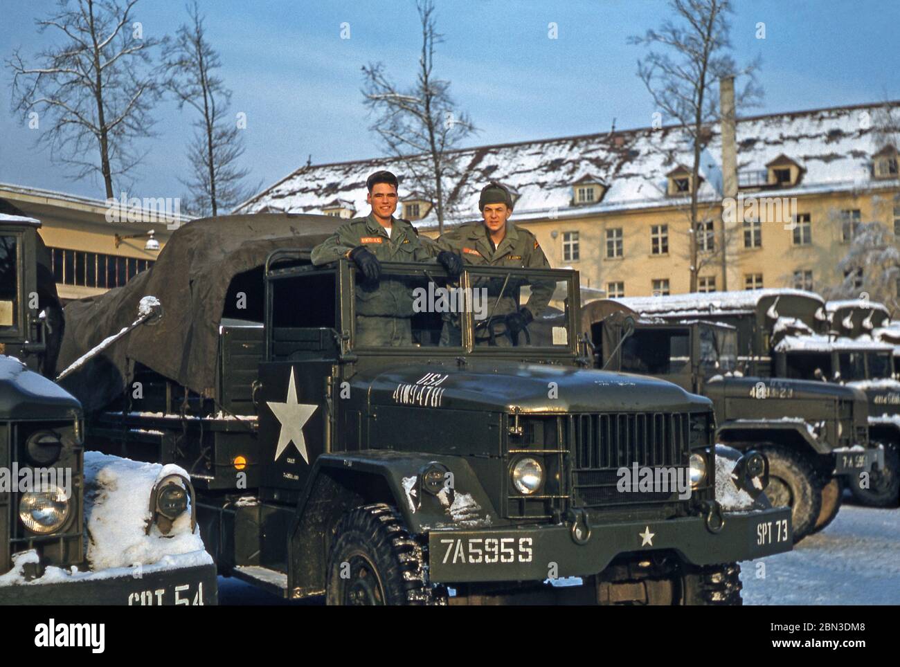 US Army soldiers stationed in Germany in the mid-1950s – two members of the 160th Signal Group are pictured on a military vehicle in the winter snow. From 1955 the 160th Signal Group provided communications throughout Germany under the US 7th (Seventh) Army during the Post-war era from an HQ at Panzer Kaserne (PK), in Böblingen (Boeblingen) near Stuttgart. The US 7th Army's HQ was at nearby Patch Barracks. Stock Photo