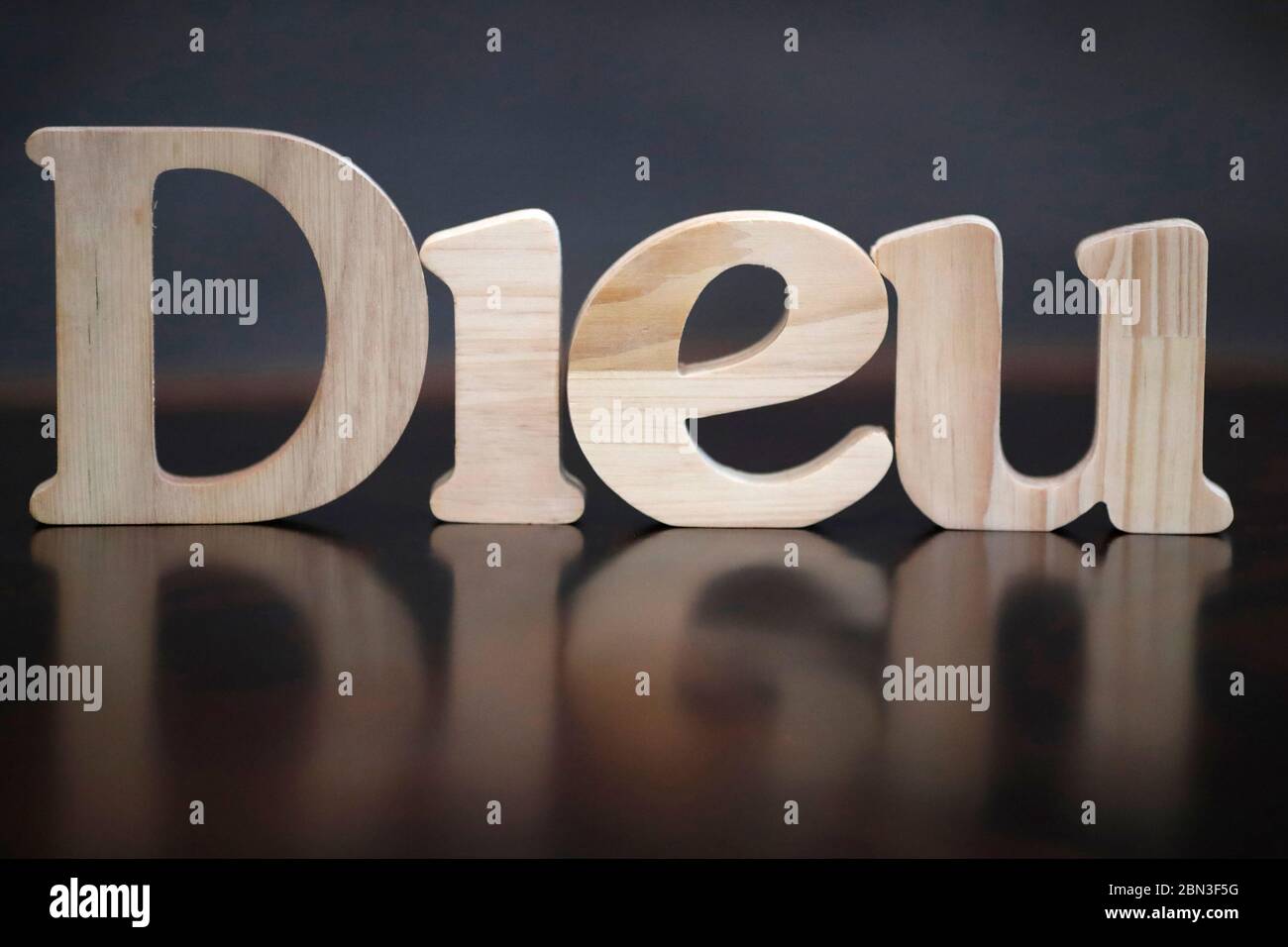 Wooden letters forming the word Dieu ( God ). Christian symbol Stock