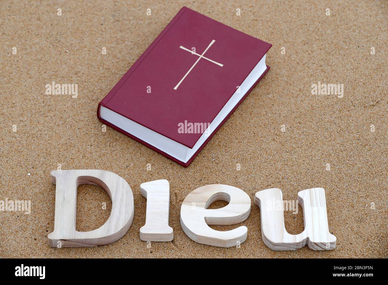 Wooden letters forming the word Dieu ( god ) with Bible on a background