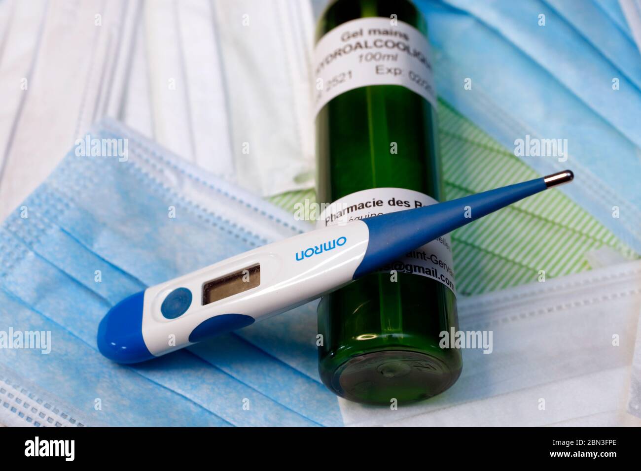 Disposable surgical mask, thermometer and antibacterial hand gel.  Reduce the risk of infection of coronavirus  ( COVID-19). Stock Photo
