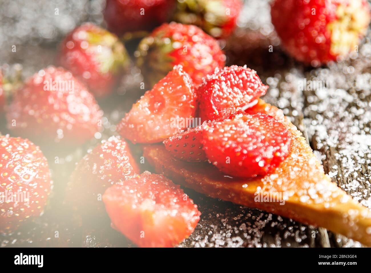 Strawberry in sugar and wooden spoon Stock Photo - Alamy