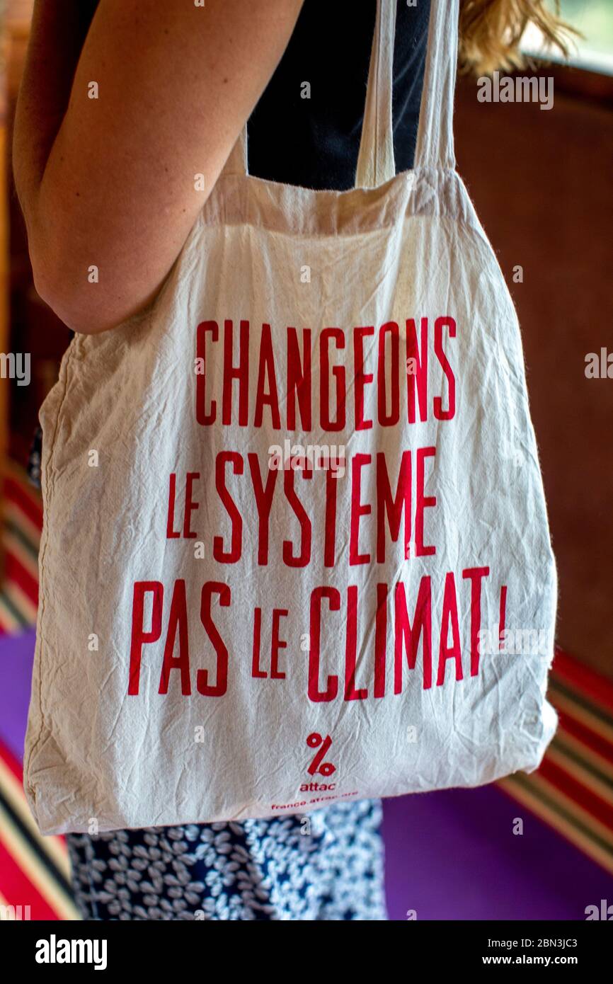 Woman wearing a bag with the slogan 'Let's change the system, not the climate' Stock Photo