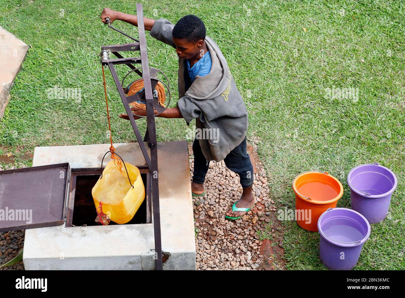 Boy drawing water from a well. Madagascar. Stock Photo