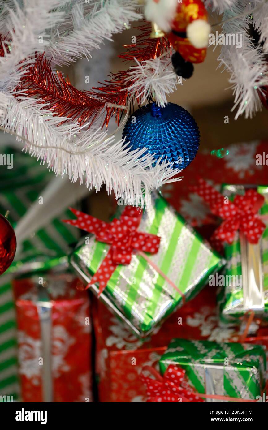 Presents under the decorated artificial Christmas tree. Stock Photo