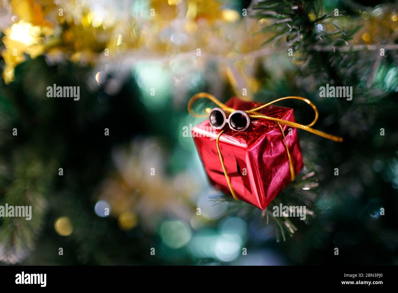 Presents under the decorated artificial Christmas tree. Stock Photo
