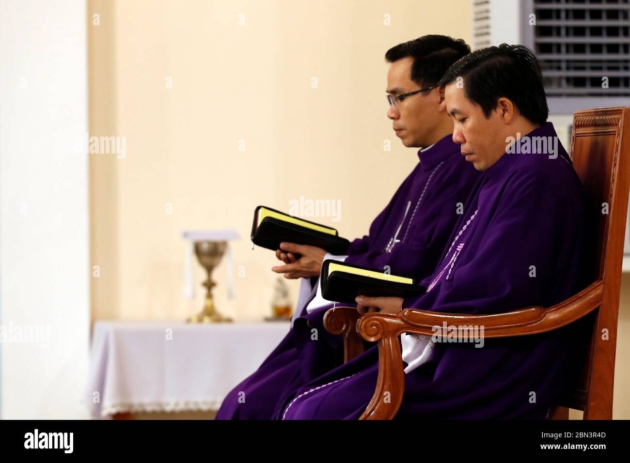 Catholic mass. Priests wearing purple roman chasuble. Quy Nhon. Vietnam
